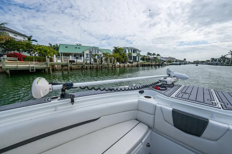 Slide: The Image of 2020 Wellcraft 302 Fisherman boat on a scenic waterfront with houses and palm trees. - 41