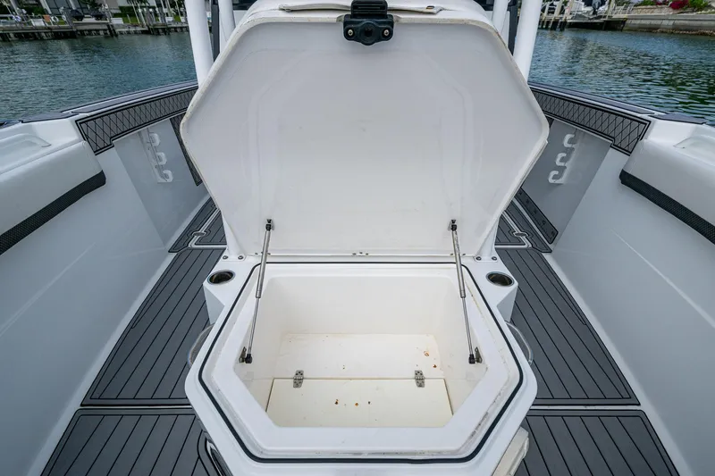 Slide: The Image of 2020 Wellcraft 302 Fisherman boat with open storage compartment on deck. - 45