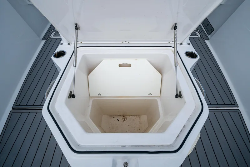 Slide: The Image of Open storage compartment on 2020 Wellcraft 302 Fisherman boat, featuring durable deck flooring. - 46
