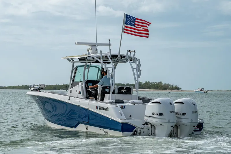 Slide: The Image of 2020 Wellcraft 302 Fisherman boat with dual Yamaha engines on open water. - 48