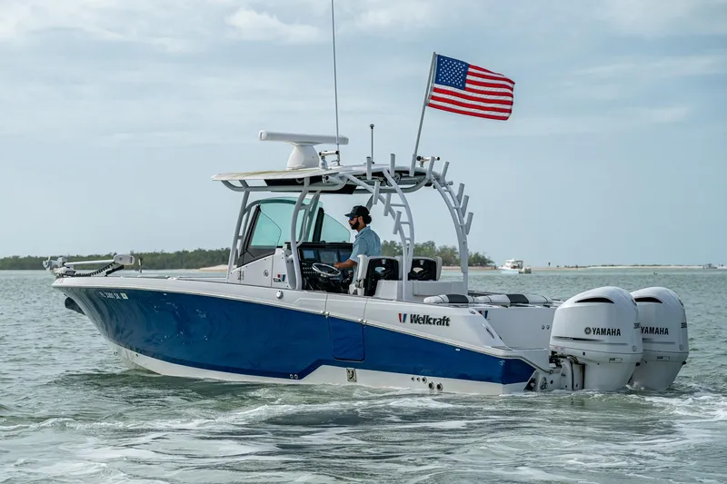 Slide: The Image of 2020 Wellcraft 302 Fisherman boat with dual Yamaha engines on open water. - 49