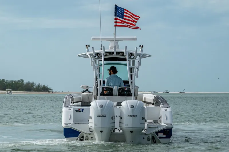 Slide: The Image of 2020 Wellcraft 302 Fisherman boat with American flag on open water. - 9