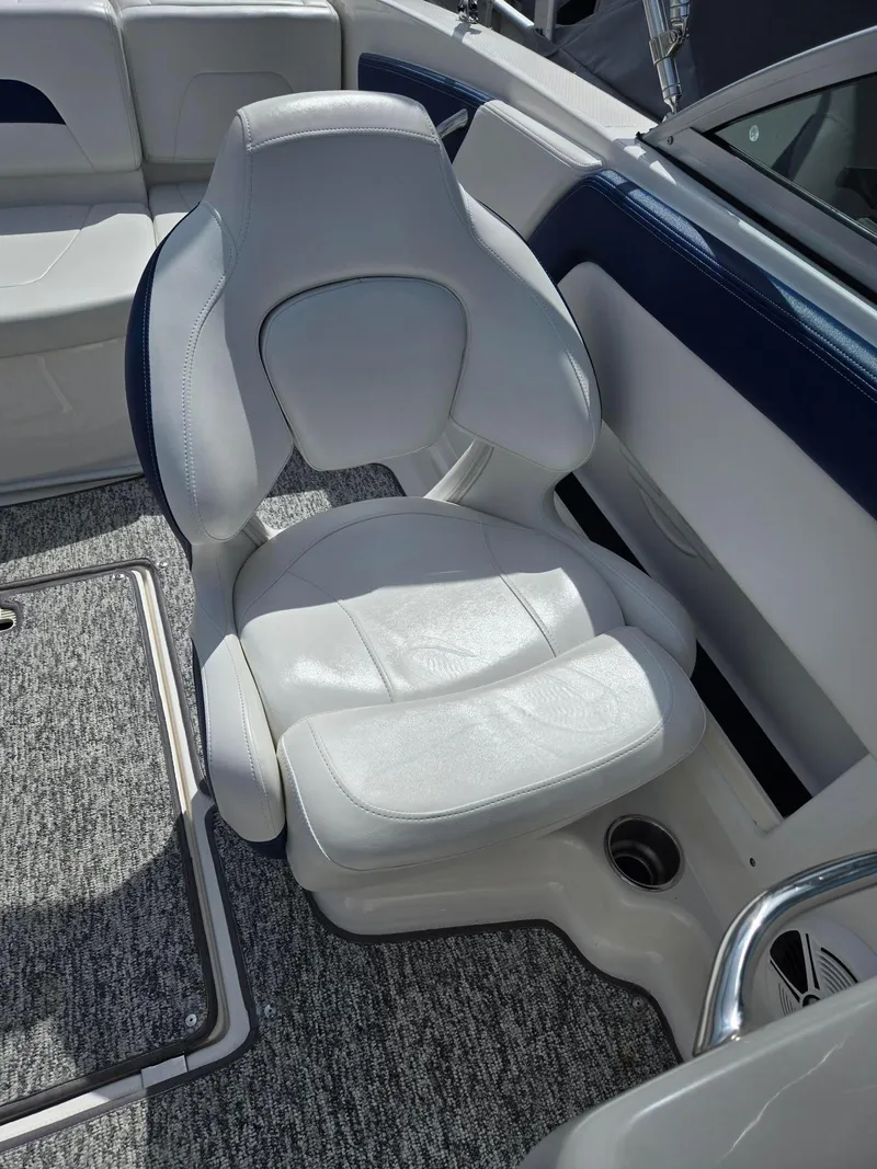 Slide: The Image of 2017 Chaparral 19H20 boat interior with white cushioned seating and carpeted flooring. - 10