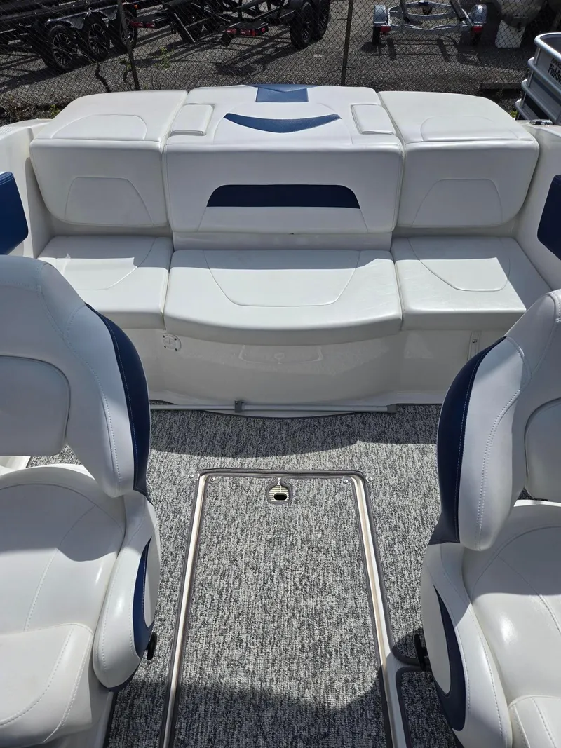 Slide: The Image of 2017 Chaparral 19H20 boat interior with white seating and gray carpet flooring. - 11