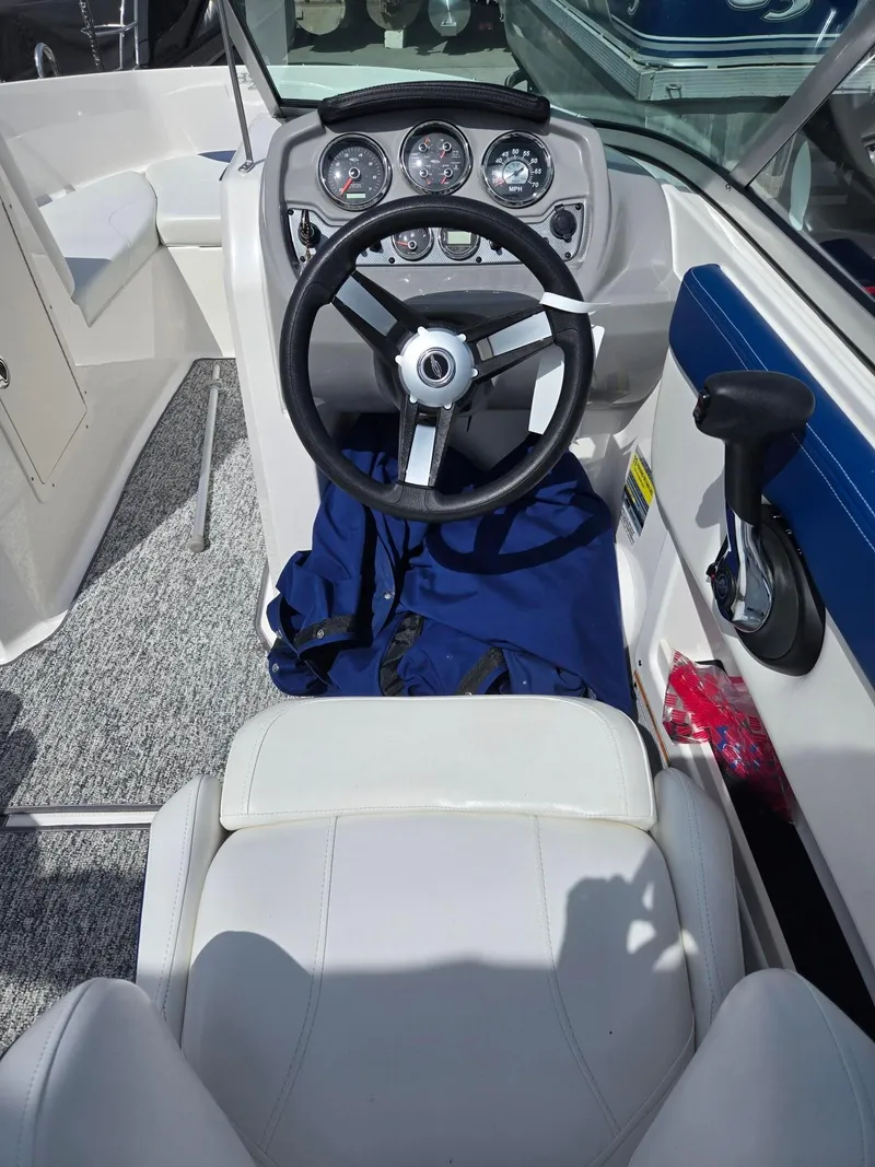 Slide: The Image of 2017 Chaparral 19H20 boat cockpit with steering wheel and control panel. - 14