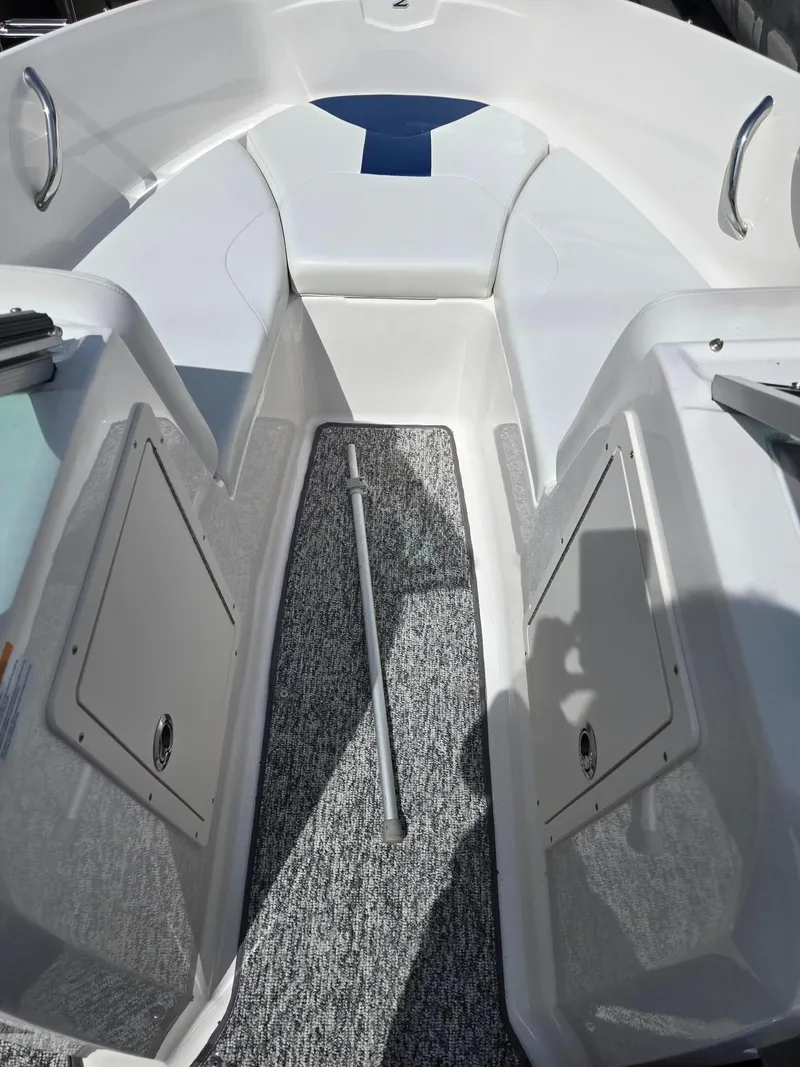 Slide: The Image of 2017 Chaparral 19H20 boat interior with seating and storage compartments. - 19