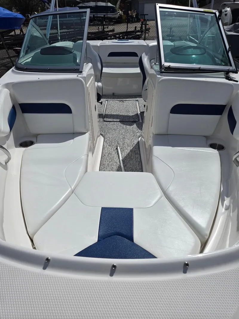 Slide: The Image of 2017 Chaparral 19H20 boat interior with white and blue seating, open windshield. - 4