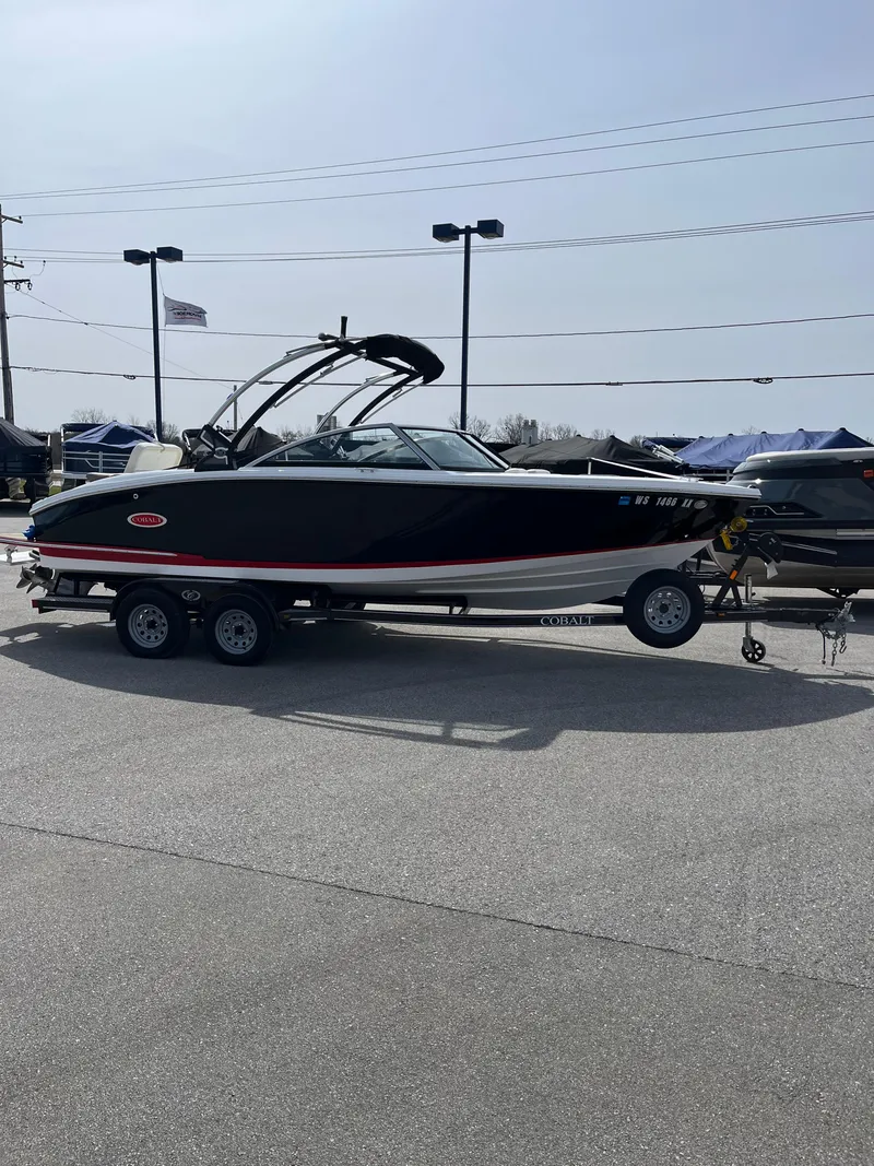 Slide: The Image of 2022 Cobalt CS23 boat on trailer in outdoor dealership lot. - 1