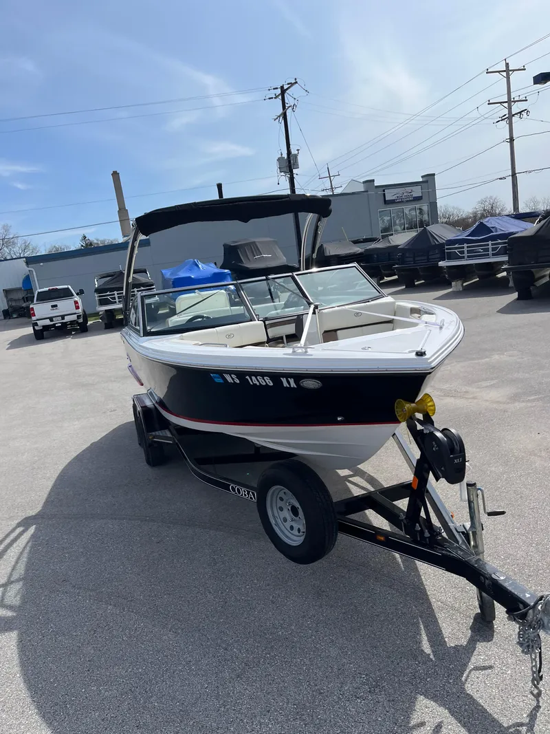 Slide: The Image of 2022 Cobalt CS23 boat on trailer in parking lot, sunny day. - 5