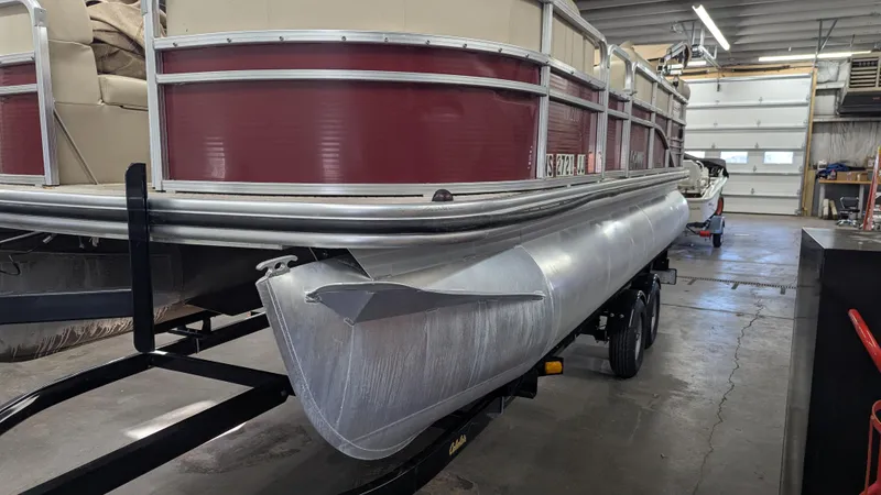 Slide: The Image of 2014 Lowe 2183 pontoon boat on trailer in a garage setting. - 2