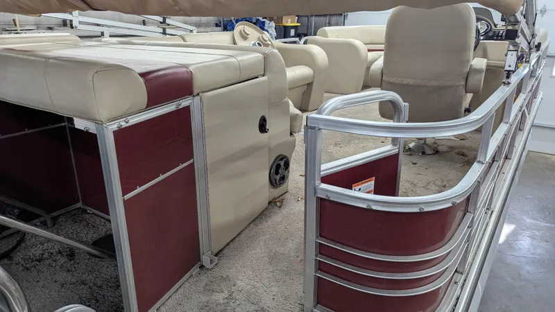 Slide: The Image of Interior of a 2014 Lowe 2183 pontoon boat with beige and maroon seating. - 6