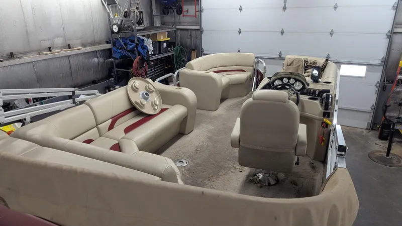 Slide: The Image of Interior of a 2014 Lowe 2183 pontoon boat in a garage setting. - 7