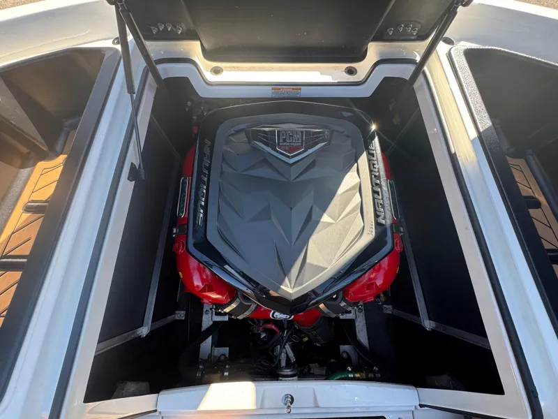 Slide: The Image of 2016 Nautique 210 boat engine compartment with PCM engine, open hatch view. - 15