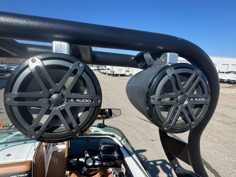 Slide: The Image of JL Audio speakers on a 2016 Nautique 210 boat, sunny day, outdoor setting. - 24