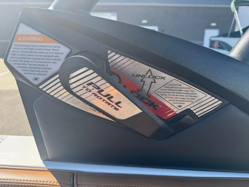 Slide: The Image of Control panel of a 2016 Nautique 210 boat with warning and unlock instructions. - 26