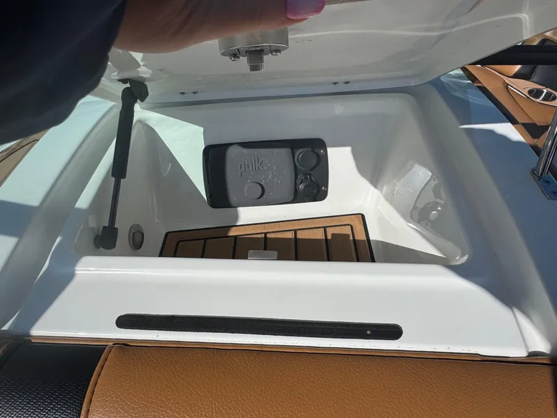 Slide: The Image of 2016 Nautique 210 boat storage compartment with Polk audio system. - 34