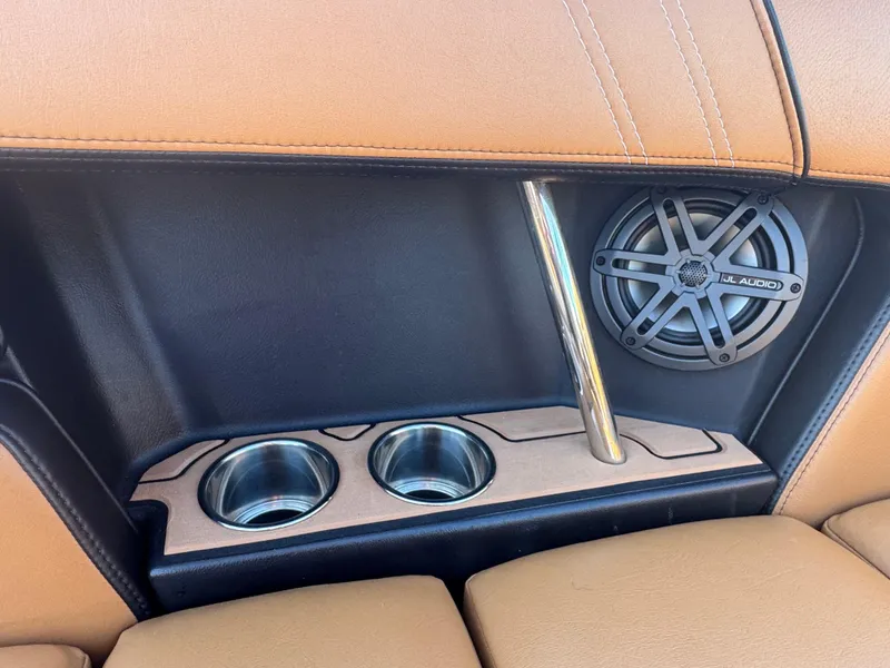 Slide: The Image of 2016 Nautique 210 interior with JL Audio speaker and dual cup holders. - 35
