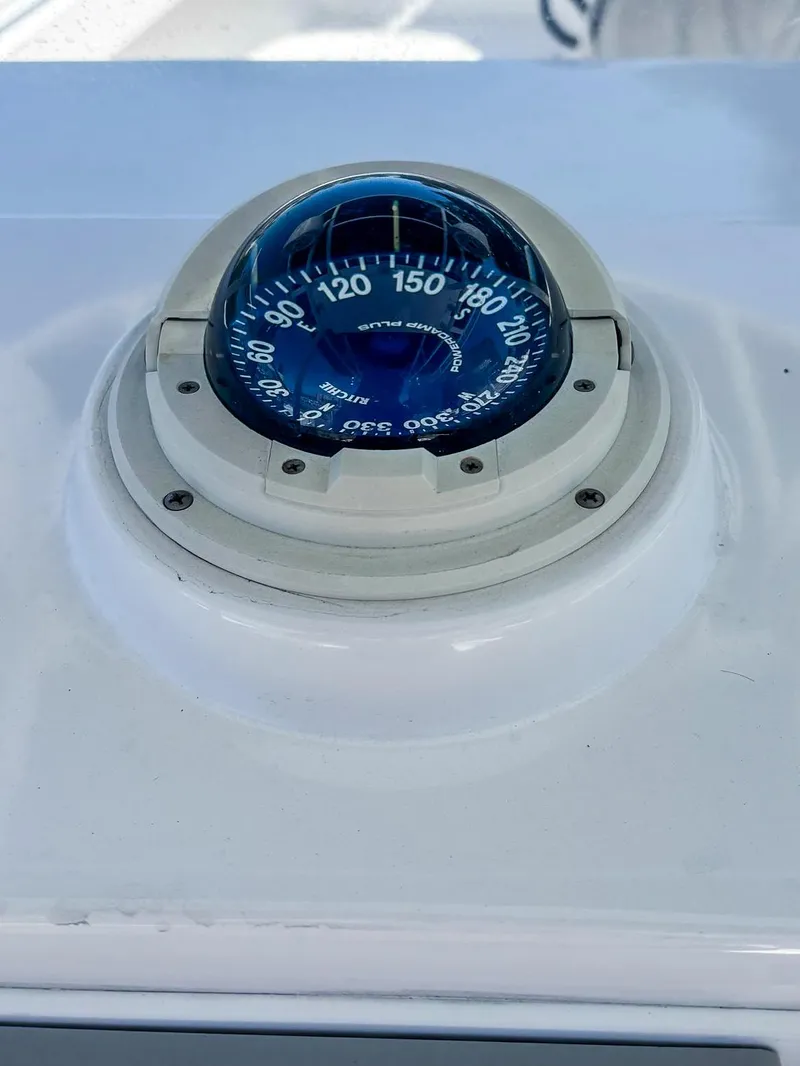 Slide: The Image of Compass on 2003 Island Runner 26 Center Console boat dashboard. - 22
