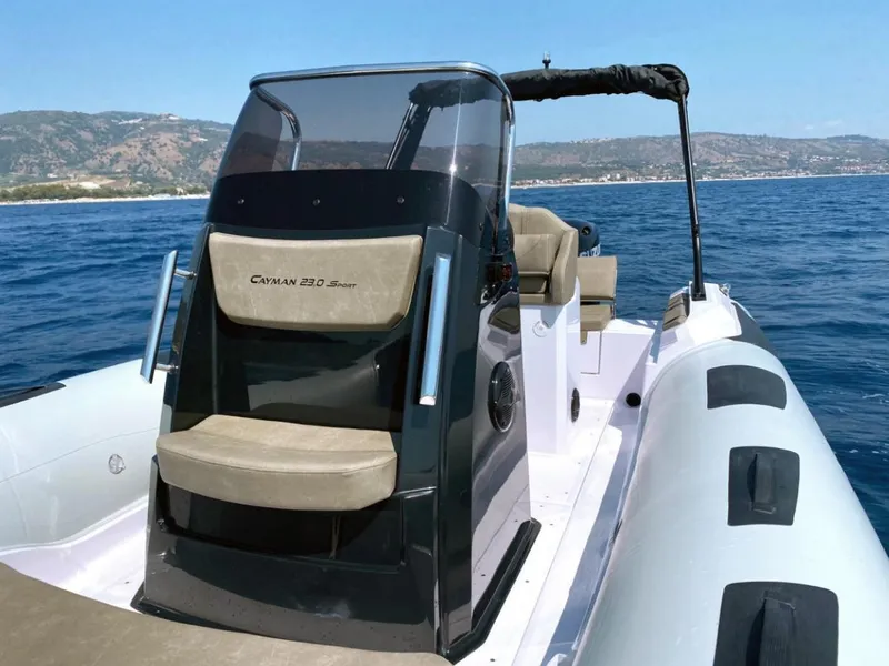 Slide: The Image of 2025 Ranieri CAYMAN 23 Sport boat on trailer, sunny day, waterfront background. - 10