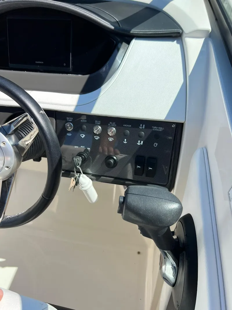 Slide: The Image of 2015 Sea Ray 290 Sundeck dashboard with steering wheel and control panel. - 10