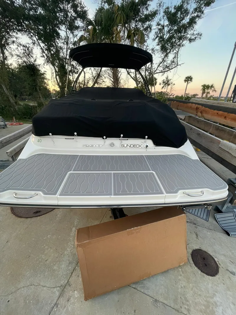 Slide: The Image of 2015 Sea Ray 290 Sundeck boat with covered deck, docked outdoors. - 14