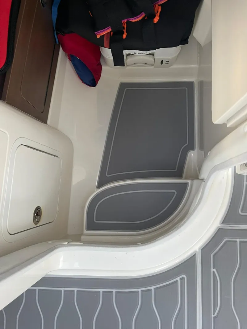 Slide: The Image of 2015 Sea Ray 290 Sundeck interior with storage and seating area. - 15