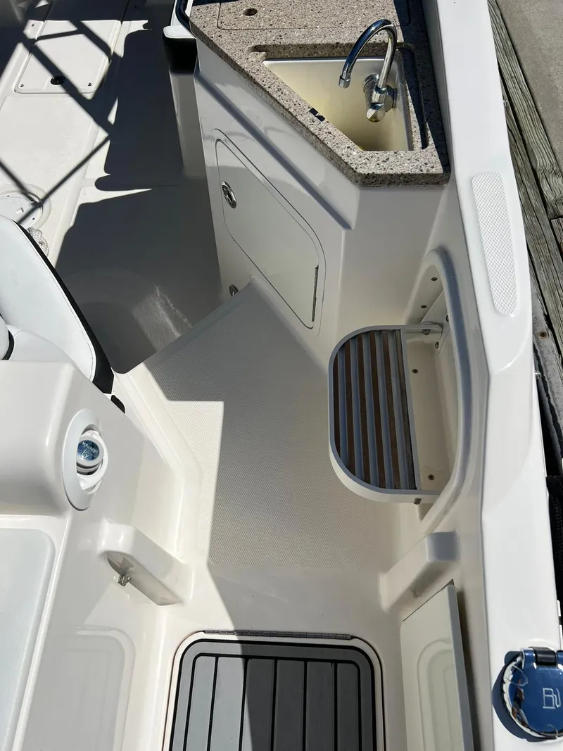 Slide: The Image of 2015 Sea Ray 290 Sundeck boat interior with sink and storage area. - 16