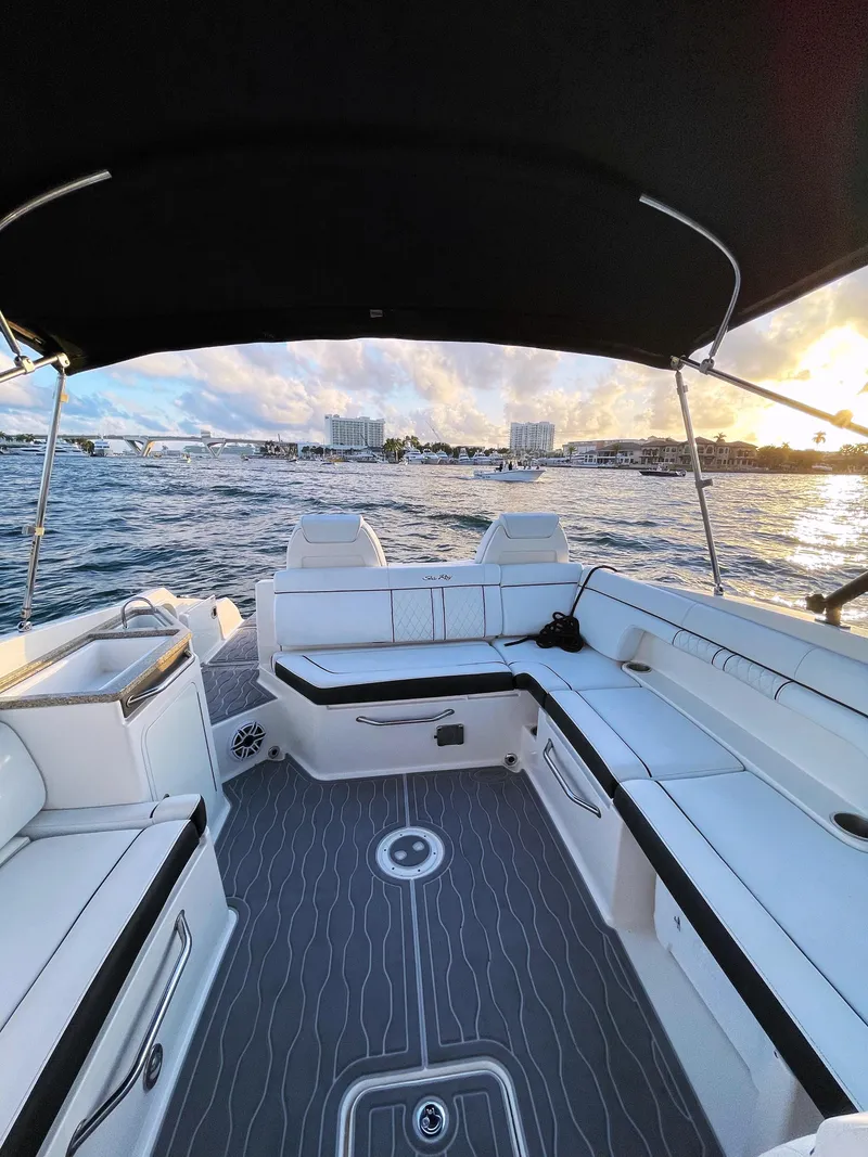 Slide: The Image of 2015 Sea Ray 290 Sundeck boat interior with seating, on a sunny day at sea. - 21