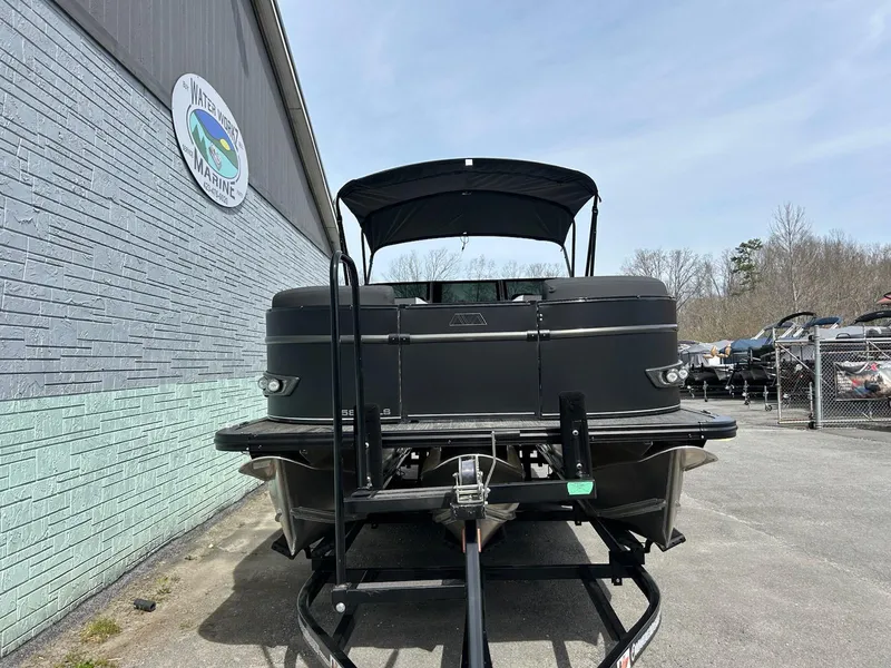 Slide: The Image of 2025 Avalon 2585 Catalina Quad Lounger boat on trailer, parked outside dealership. - 3