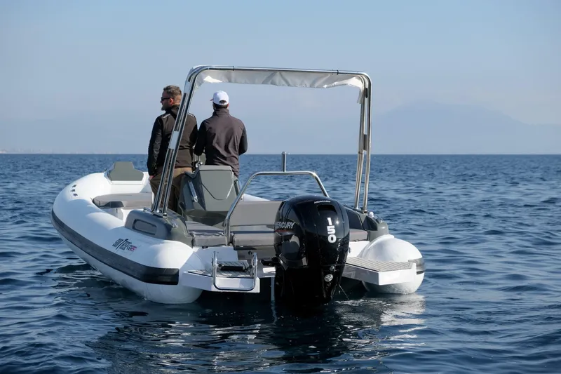 Slide: The Image of Custom Sunrise 24 boat on open water, 2024 model, with two people onboard. - 9