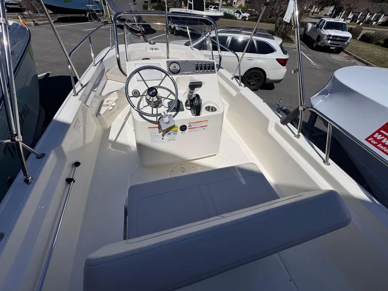 Slide: The Image of 2025 Boston Whaler 170 Montauk boat interior with steering wheel and seating. - 5