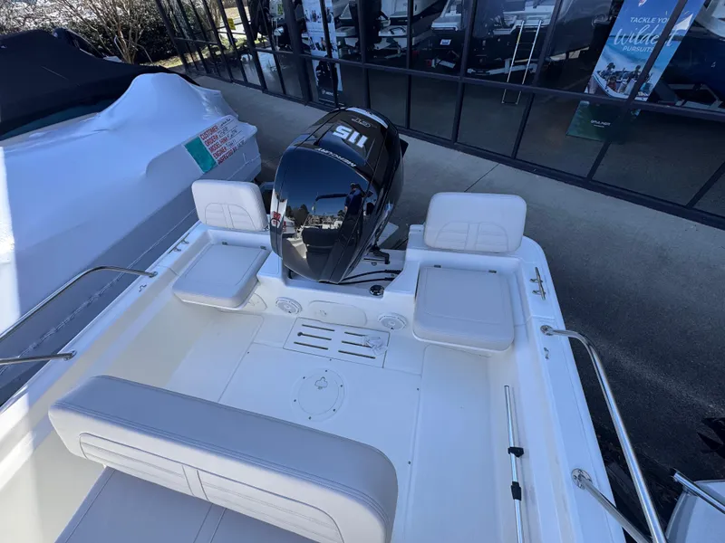 Slide: The Image of 2025 Boston Whaler 170 Montauk boat interior with seating and outboard motor. - 7