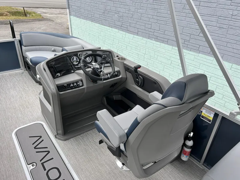 Slide: The Image of 2025 Avalon LSZ 2585 Quad Lounger Shift boat interior with modern helm and seating. - 8