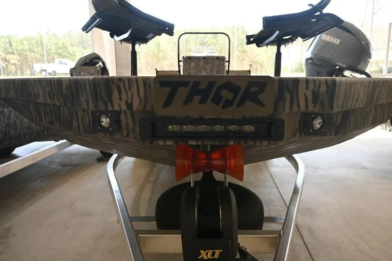 Slide: The Image of 2025 Thor Lake Hammer 1900CC boat on trailer, featuring rugged design and XLT branding. - 11