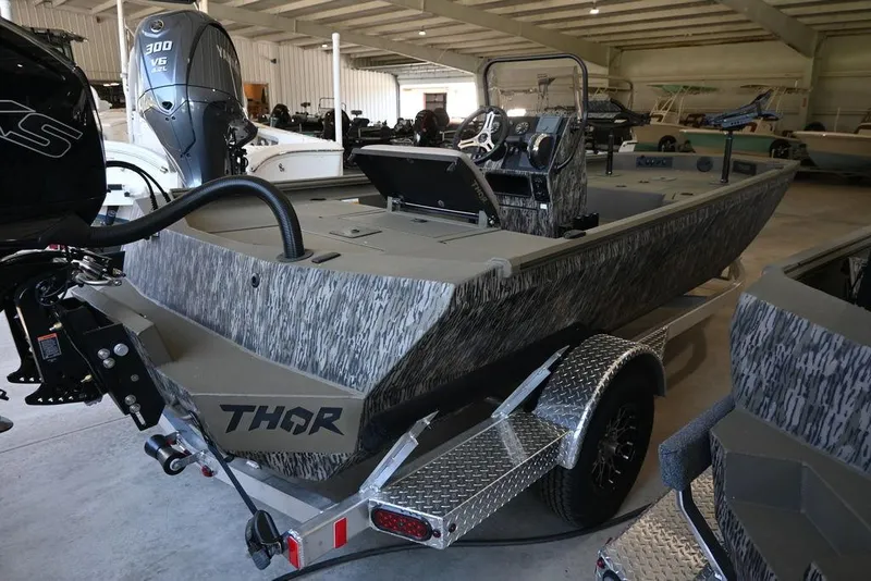 Slide: The Image of 2025 Thor Lake Hammer 1900CC boat in showroom, featuring camouflage design and powerful outboard motor. - 4