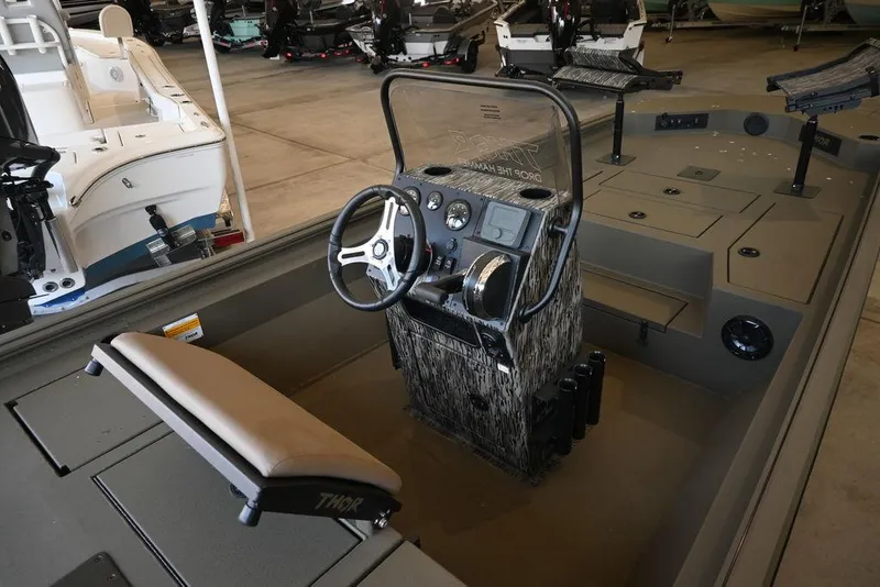 Slide: The Image of 2025 Thor Lake Hammer 1900CC boat interior with steering console and seating. - 5