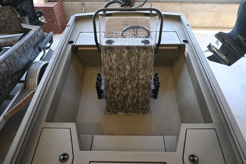 Slide: The Image of 2025 Thor Lake Hammer 1900CC boat interior with steering console and seating. - 6
