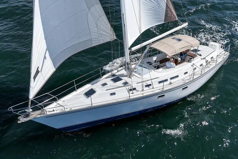 The Image of Sailboat Morgan 45 Catalina 1992 cruising on open water under clear skies. - 0