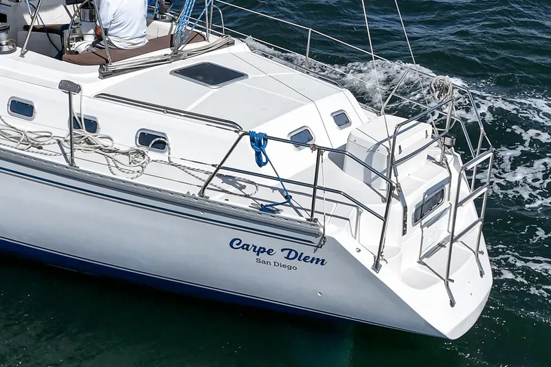 Slide: The Image of 1992 Morgan 45 Catalina sailboat navigating ocean waters near a city skyline. - 13