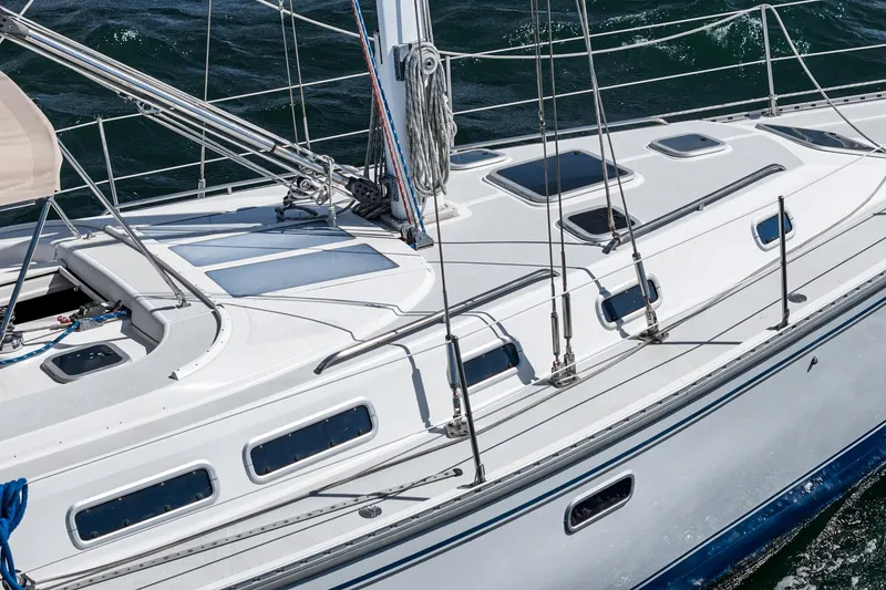 Slide: The Image of 1992 Morgan 45 Catalina sailboat on water, featuring sleek white and blue design. - 16