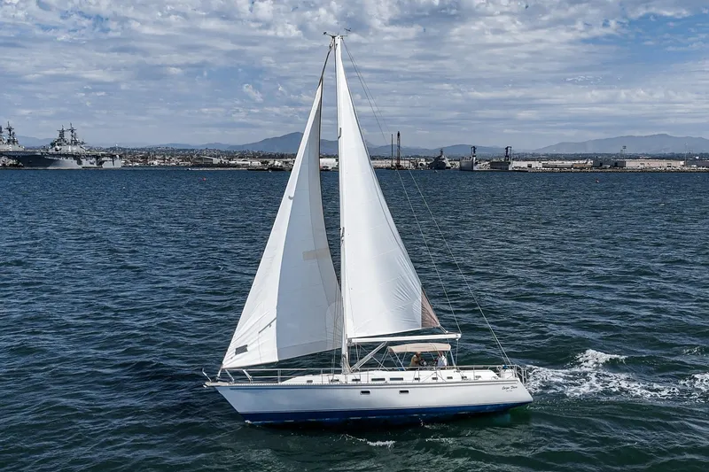 Slide: The Image of Sailing yacht Morgan 45 Catalina 1992 gliding on open sea under clear skies. - 20