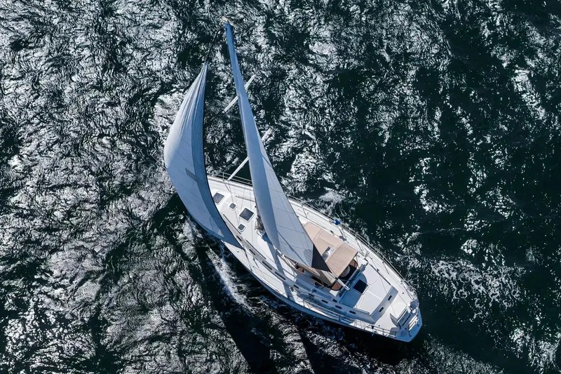 Slide: The Image of Aerial view of 1992 Morgan 45 Catalina sailboat navigating through shimmering ocean waters. - 26
