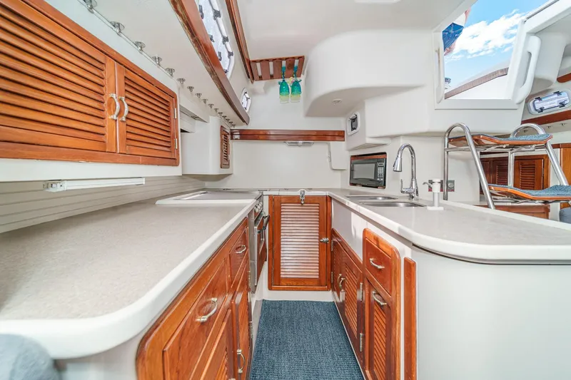 Slide: The Image of 1992 Morgan 45 Catalina sailboat cruising on open water under clear skies. - 3