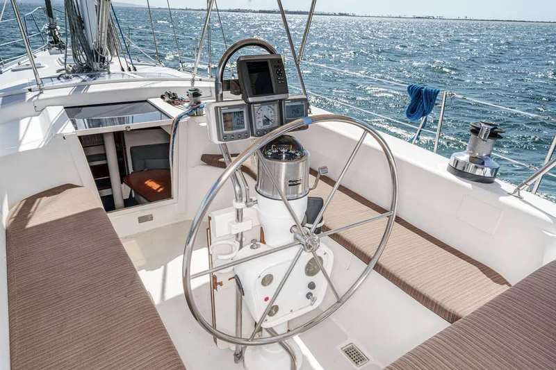 Slide: The Image of 1992 Morgan 45 Catalina sailboat cockpit with steering wheel, navigation instruments, and ocean view. - 30