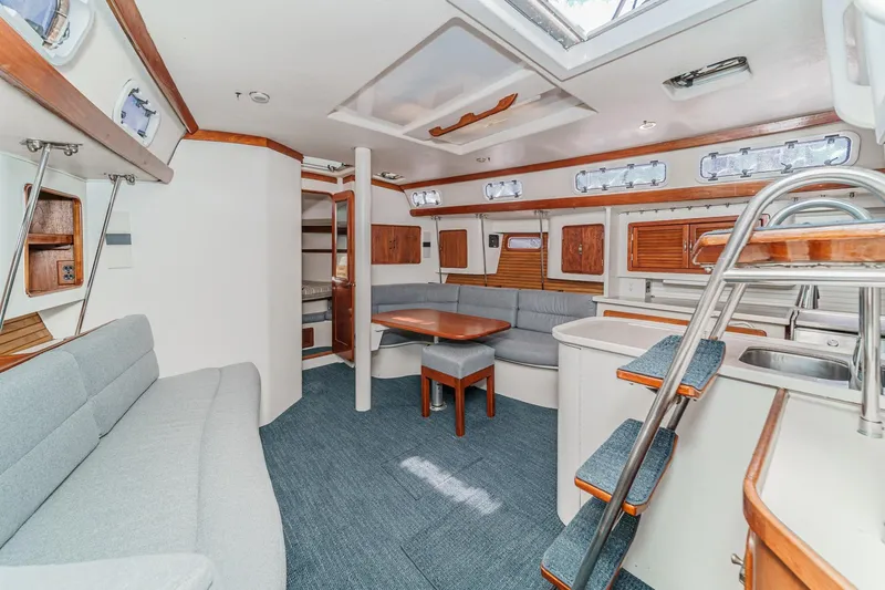Slide: The Image of Interior of 1992 Morgan 45 Catalina yacht with modern seating and wooden accents. - 34