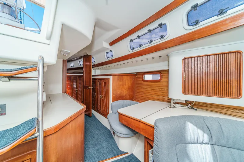 Slide: The Image of Interior of 1992 Morgan 45 Catalina sailboat with wood accents and seating area. - 45