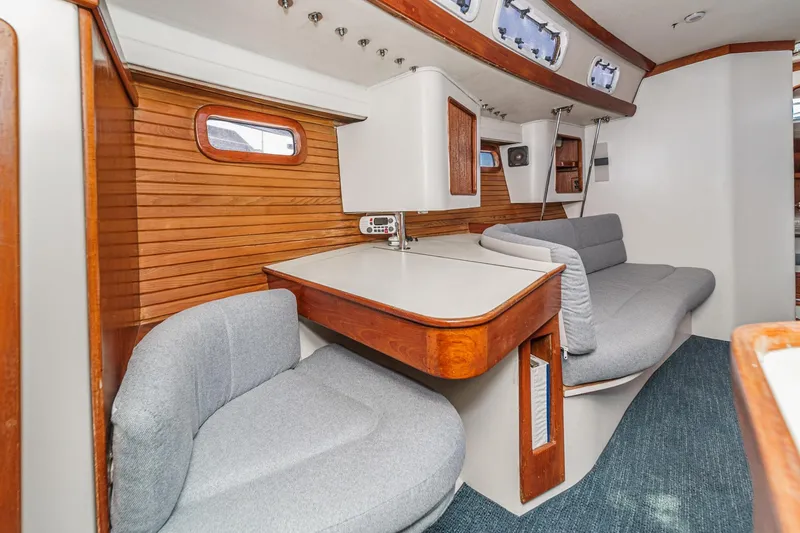 Slide: The Image of Interior of 1992 Morgan 45 Catalina yacht with wooden accents and gray seating. - 46