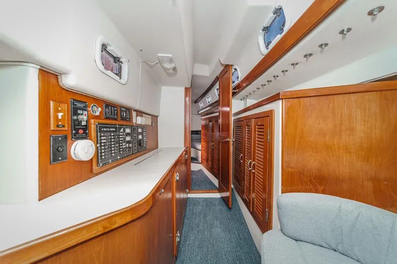 Slide: The Image of Interior of 1992 Morgan 45 Catalina yacht with wood paneling and control panel. - 47