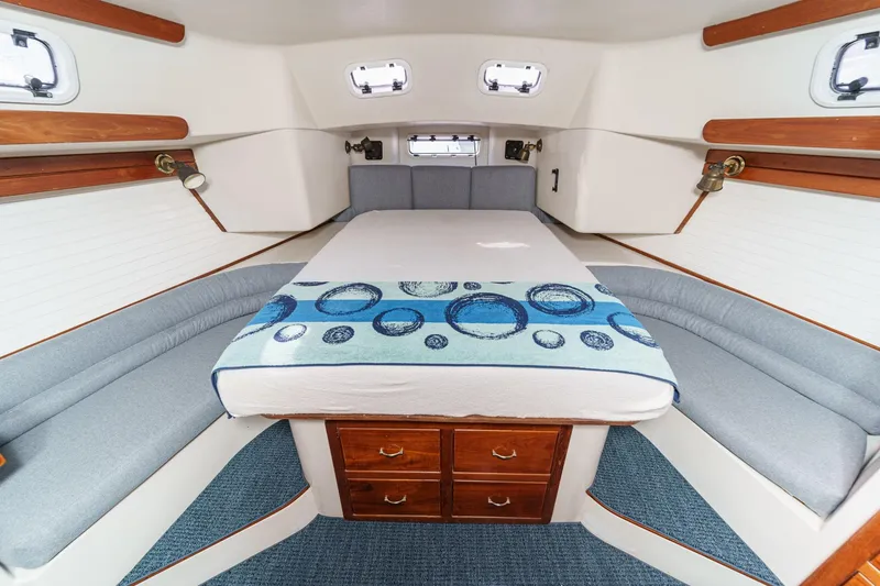 Slide: The Image of Luxurious 1992 Morgan 45 Catalina yacht interior with cozy bed and elegant wood accents. - 48