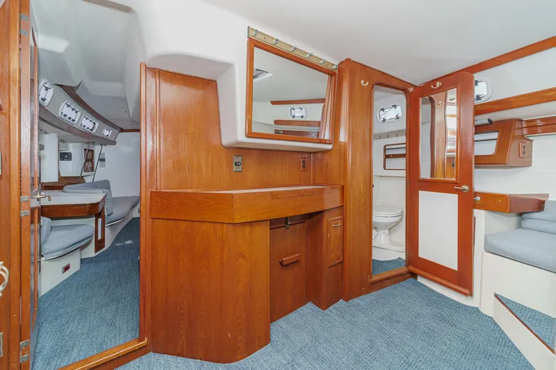 Slide: The Image of Interior of 1992 Morgan 45 Catalina yacht with wooden cabinetry and blue carpet. - 50